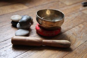 tibetan singing bowl with mallet and pebbles